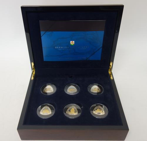 A set of twelve silver and gilt curved triangular commemorative coins, 2007, commemorating Bermuda shipwrecks, with a Royal Mint Certificate of Authen