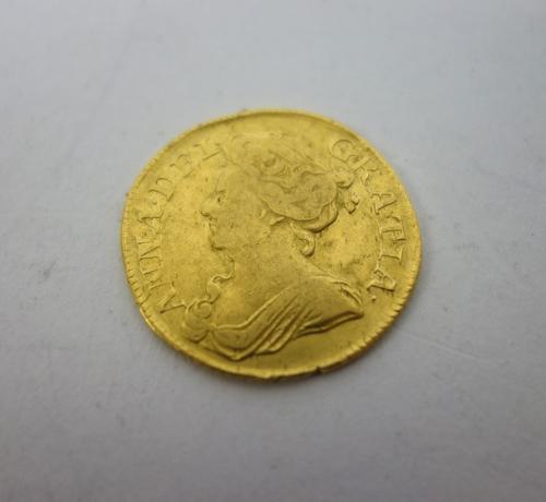 An Anne guinea 1713, post union with Scotland, with traces of evidence of mounting to the tooled rim.