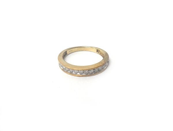 A 9ct gold and diamond set eleven stone half hoop eternity ring, mounted with a row of circular cut diamonds, detailed 9 K, ring size N and a half, wi