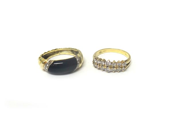 An 18ct gold ring, claw set with two rows of seven circular cut diamonds, ring size J and a gold, black onyx and diamond set ring, with ridged decorat