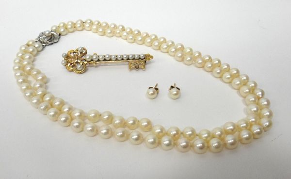 A two row necklace of uniform cultured pearls, on a white gold and cultured pearl clasp, detailed 750, a gold and cultured pearl brooch, designed as a