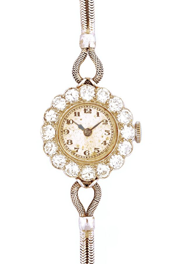 A lady's diamond set dress bracelet wristwatch, with a circular unsigned jewelled Swiss movement, the unsigned silvered dial with black Arabic numeral