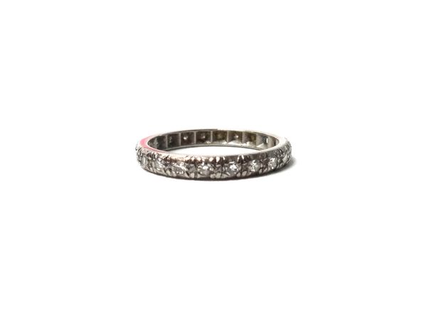 A white gold and diamond set full eternity ring, mounted with circular cut diamonds (one diamond lacking), ring size N.