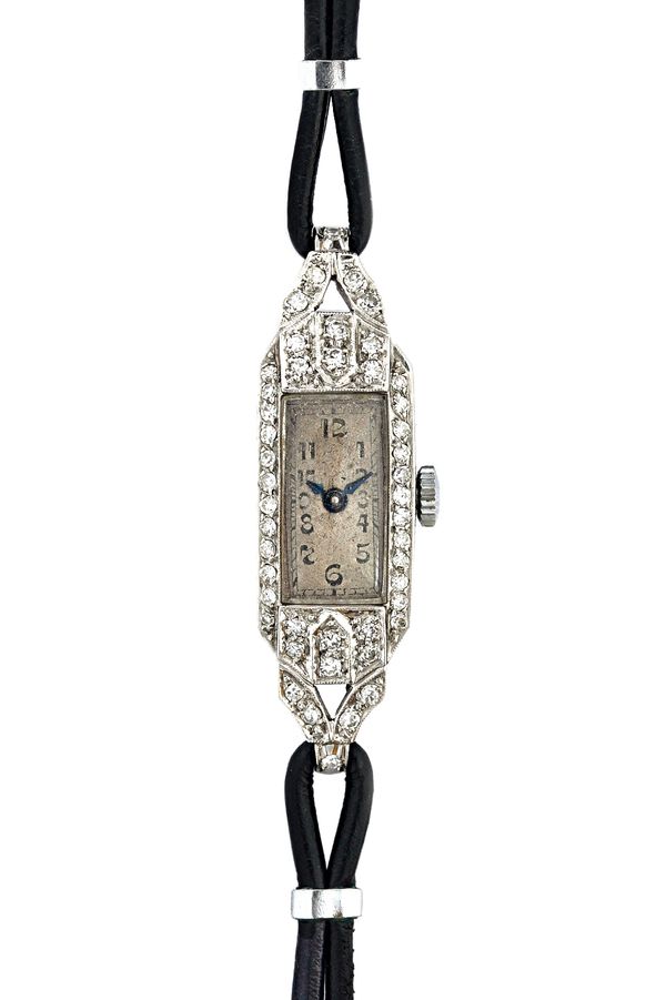 A lady's platinum cased and diamond set dress wristwatch, with a jeweled lever movement, the rectangular silvered dial with black Arabic numerals, the