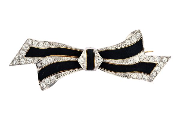 A two colour gold, diamond and black enamelled brooch, designed as a tied bow, with diamond set terminals, mounted with cushion shaped diamonds, lengt