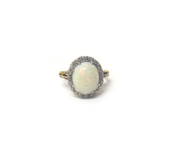 A gold, opal and diamond ring, claw set with the oval opal at the centre, within a surround of circular cut diamonds, detailed 18 CT, ring size P, wit