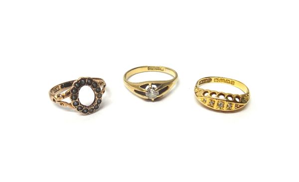 A Victorian 18ct gold and diamond single stone ring, claw set with a cushion shaped diamond, Birmingham 1894, an 18ct gold and diamond set five stone