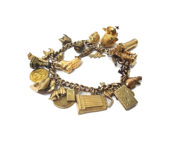 A gold curb link charm bracelet, with a boltring clasp, fitted with a variety of mostly gold charms, including a koala bear, a poodle with a lady's sh