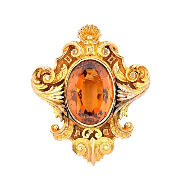 A Cartier gold and citrine brooch, in a Rococo shaped design, with a scallop motif at the top, collet set with an oval cut citrine at the centre, deta