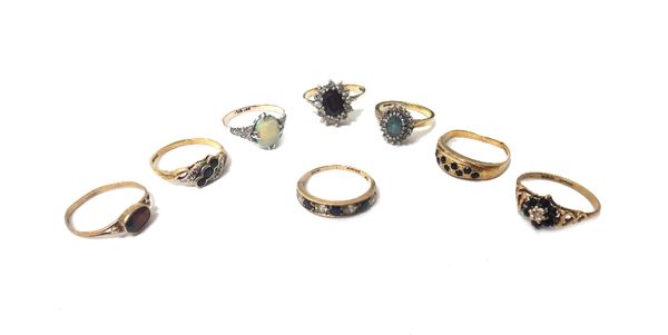 An 18ct gold, diamond and pale blue gem set oval cluster ring, a 9ct gold, sapphire and diamond set seven stone cluster ring, an opal single stone rin