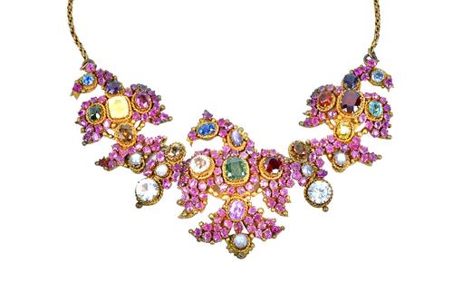 An Eastern ruby and vary coloured gemstone and gem set necklace, designed principally as three birds having outspread wings, mounted with a variety of