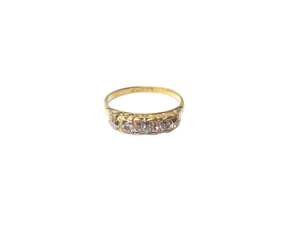 An 18ct gold and diamond set five stone ring, mounted with a row of cushion shaped diamonds graduating in size to the centre stone, the mount decorate