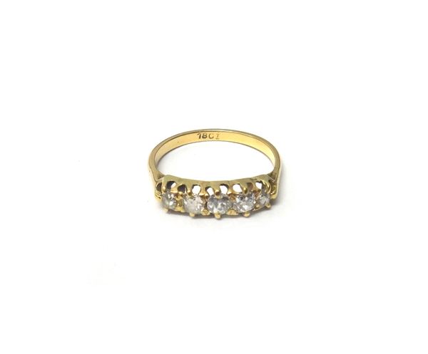 A gold and diamond set five stone ring, claw set with a row of cushion shaped diamonds, graduating in size to the centre stone, detailed 18 CT, ring s