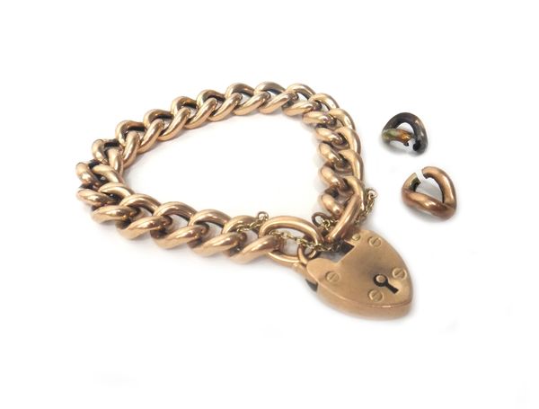 A gold hollow curb link bracelet, on a gold heart shaped padlock clasp, fitted with a safety chain, with two spare links, combined weight 2 gms.