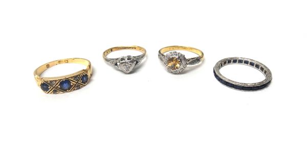 An 18ct gold, sapphire and diamond ring, mounted with three cushion shaped sapphires and with two pairs of small cushion shaped diamonds, a gold and p