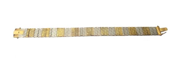 A two colour gold bracelet, in a wide lozenge shaped link design, on a snap clasp, detailed 15 KT, length 18.5cm, weight 23.6 gms.