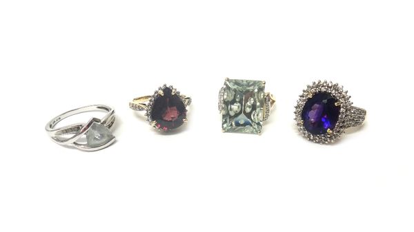 A 9ct gold, amethyst and colourless gem set oval cluster ring, two 9ct gold and gem set rings and a white gold, pale blue and colourless gem set ring,