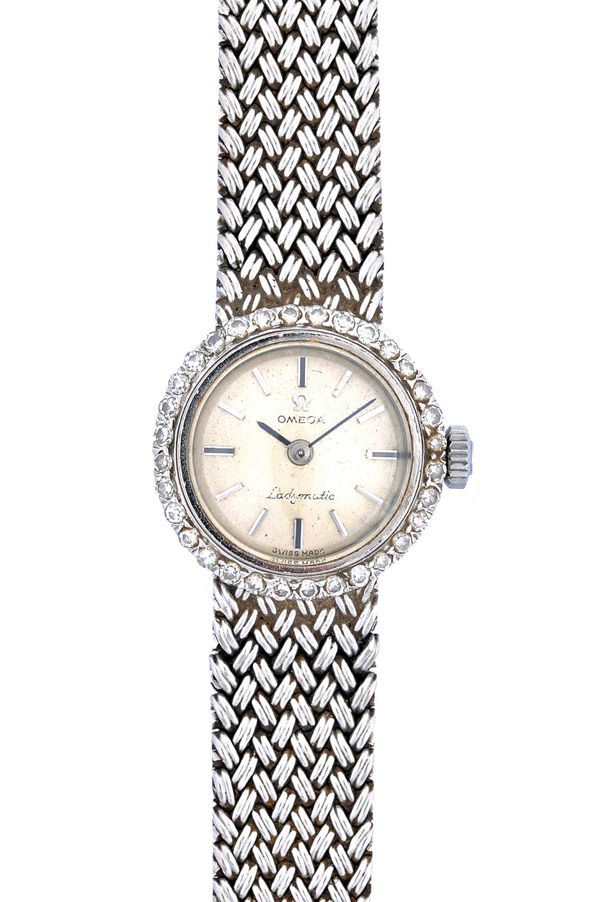 An Omega Ladymatic 18ct white gold and diamond set dress bracelet wristwatch, the jewelled movement detailed Omega Watch Co, the signed silvered dial