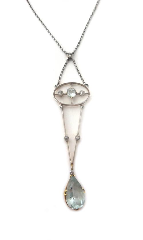 A gold, aquamarine and diamond pendant necklace, the top mounted with a cushion shaped aquamarine between two rose cut diamonds, within a pierced oval