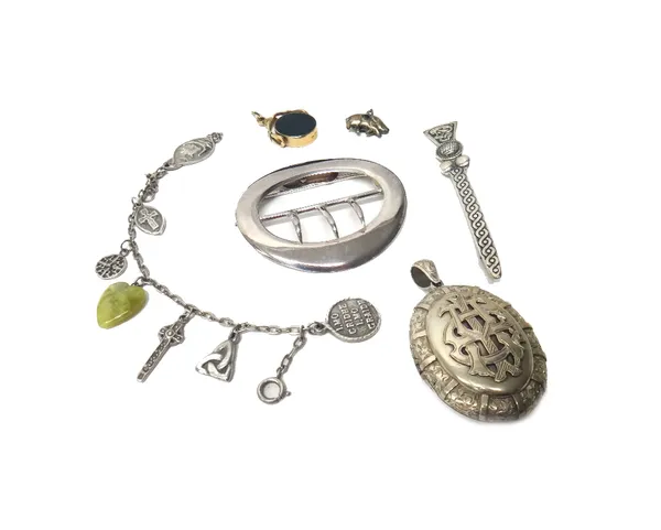 A silver oval waist belt buckle, Chester 1907, a Victorian oval pendant locket, the front mounted with a monogram, a 9ct gold mounted agate set rotati