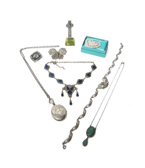 A Victorian oval pendant locket with engraved decoration to the front, with a silver neckchain, three further necklaces, a filigree butterfly brooch,