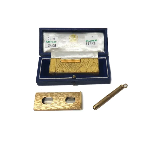 A Kutchinsky 9ct gold mounted steel slide action cigar cutter, with bark textured decoration, London 1977, a 9ct gold cased propelling toothpick with