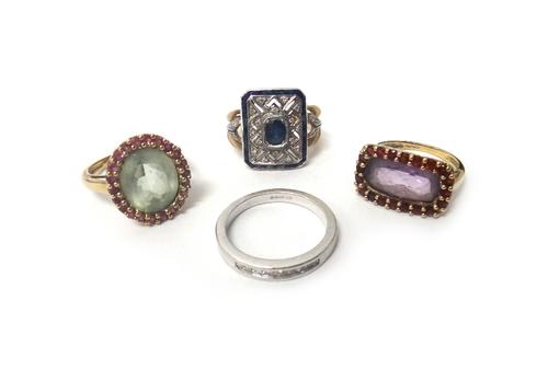 A 9ct gold, sapphire and diamond set ring, in a rectangular panel shaped design, mounted with the principal oval cut sapphire at the centre, a 9ct whi