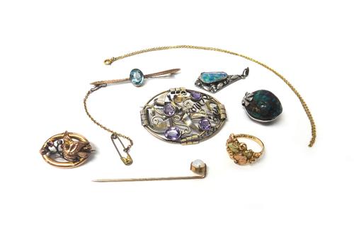 A two colour gold ring, designed as vine leaves and grapes, with a case, a gold, seed pearl and garnet set brooch, with a bird motif, detailed 9 CT, a