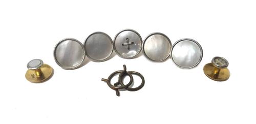 Four gold mounted mother of pearl dress buttons, detailed 18 CT and two loop fittings, another gold mounted mother of pearl dress button, with a centr