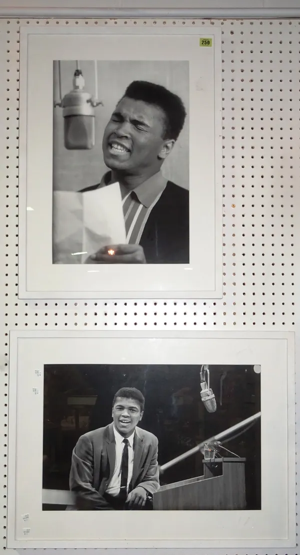 A pair of 20th century framed black and white photographic prints of Mohammed Ali, the largest 71cm x 53cm, (2). C1