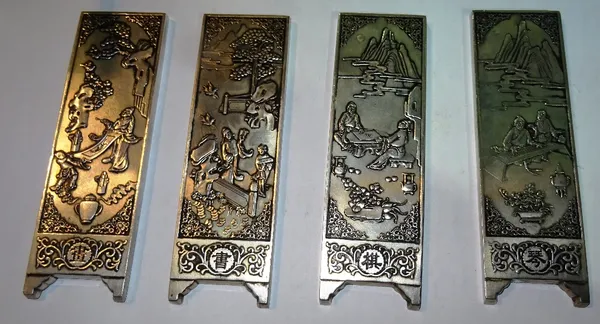 A group of four probably 20th century Chinese silvered metal plaques, depicting figures in landscapes, each 4.5cm wide x 15cm long, (4). CAB