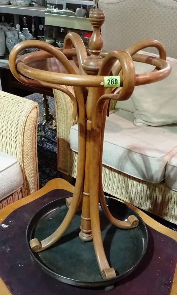 A 20th century bentwood and tole painted stick stand and a circular embossed brass plate, (2).  H5