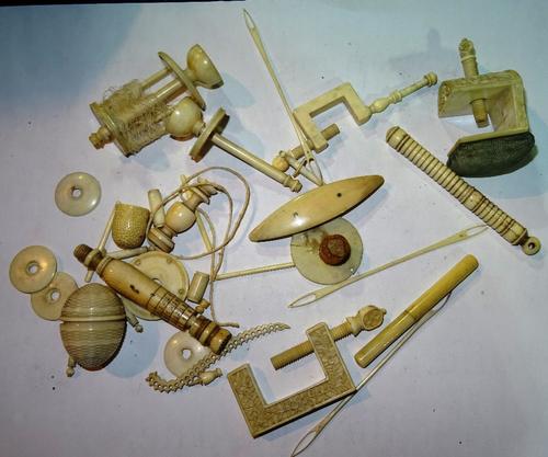 A quantity of ivory sewing accessories and related small items, late 19th/early 20th century, including; a Chinese carved pin cushion, a table clamp,