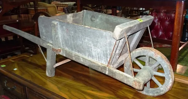 A 19th century small wooden garden wheelbarrow.  G10