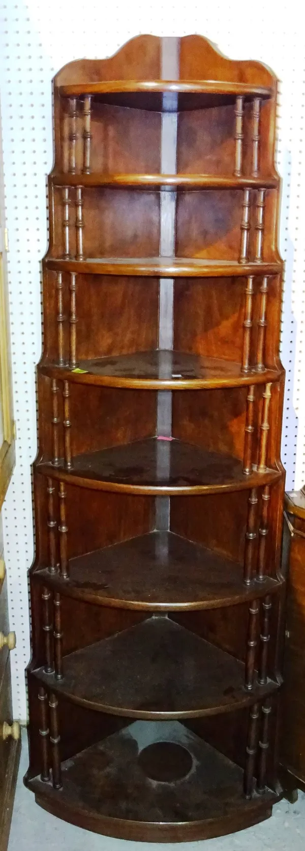 A 20th century mahogany shelved corner unit in the Victorian manner, 62cm wide x 186cm high.  M11