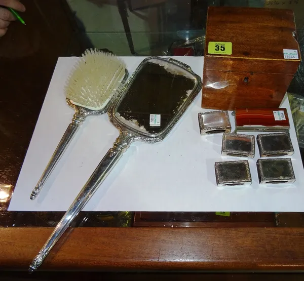 Collectables, comprising; a 19th century mahogany tea caddy, a silver mounted dressing table mirror and brush, various silver match box holders detail