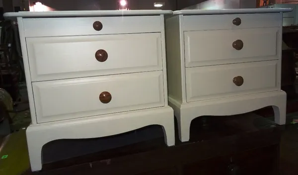 A pair of 20th century white painted three drawer bedside tables, 53cm wide x 51cm high, (2).   J7
