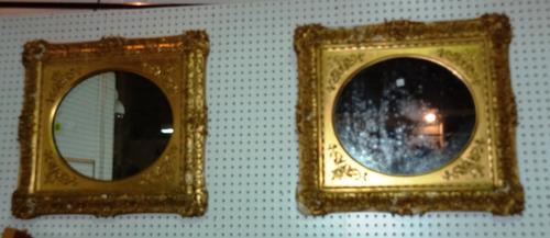 A pair of early 20th century oval gilt framed wall mirrors, 59cm wide x 67cm high, (2).   H10