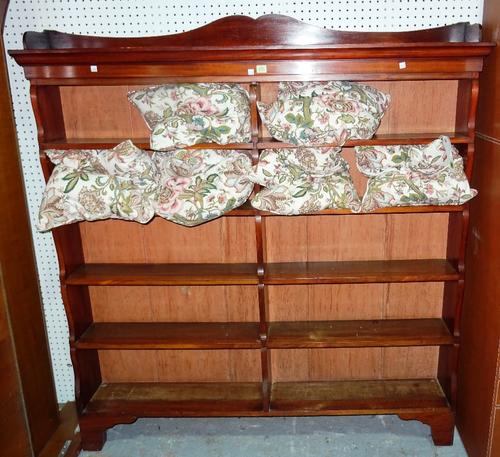 A Victorian mahogany open bookshelf, of wavy form, 150cm wide x 154cm high.   H11