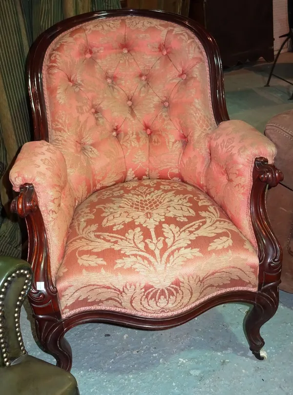 A Victorian walnut framed armchair, on scroll supports.  D8