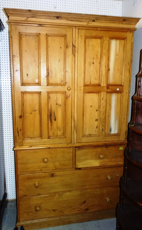 A 20th century pine double wardrobe over two short and two long drawers, 120cm wide x 224cm high.   M11
