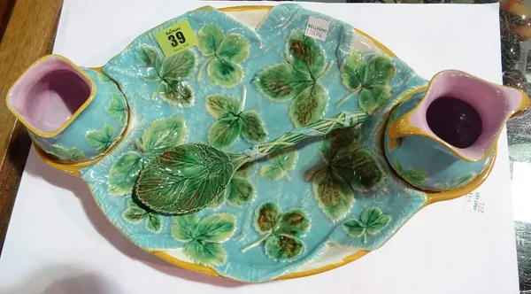 A George Jones majolica strawberry set, late 19th century, comprising an oval tray, a two handled jug, a pouring pot and spoon, all with leaf moulded
