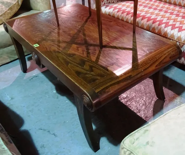 A 20th century oak coffee table, with rounded ends, on sabre supports, 110cm wide x 46cm high.   E5