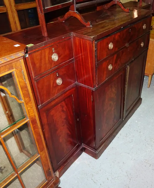 A 19th century mahogany breakfront secretaire side cabinet, with fitted drawer over pair of cupboards, flanked by four short drawers and a further pai