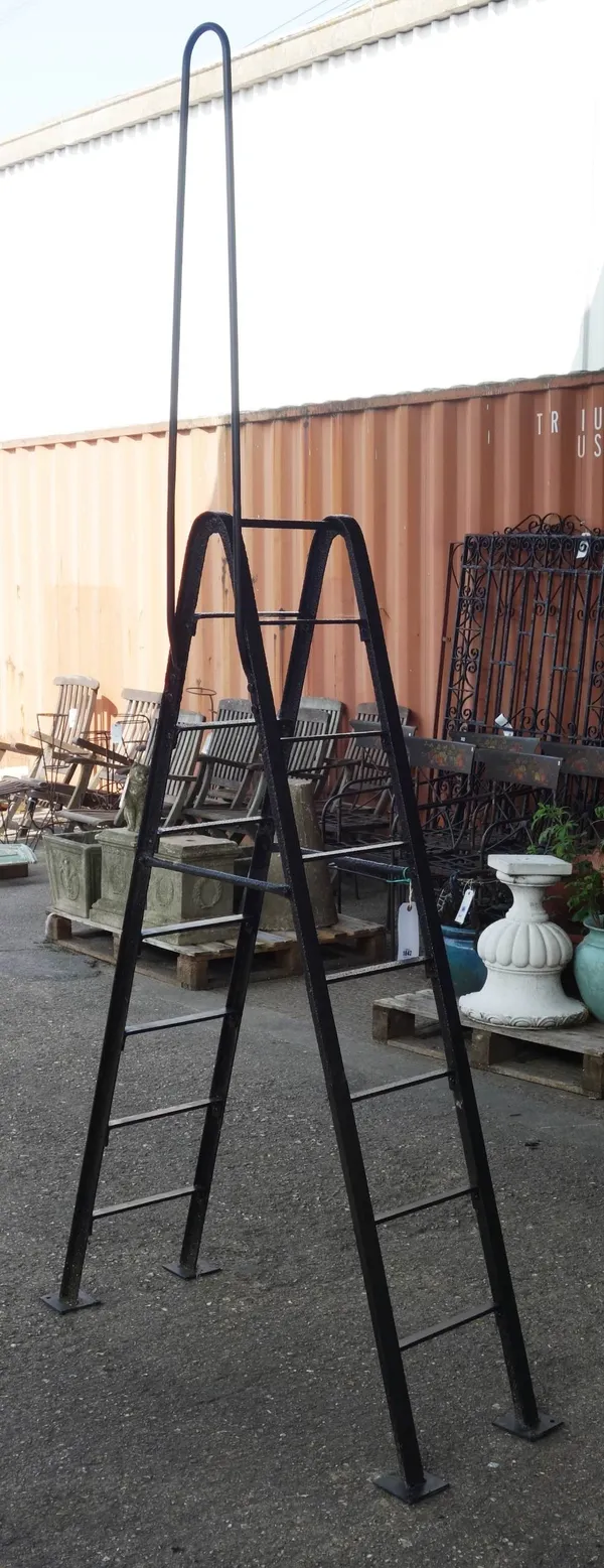 A black painted wrought iron stile of 'A' frame form, 120cm wide x 266cm high.  OUT