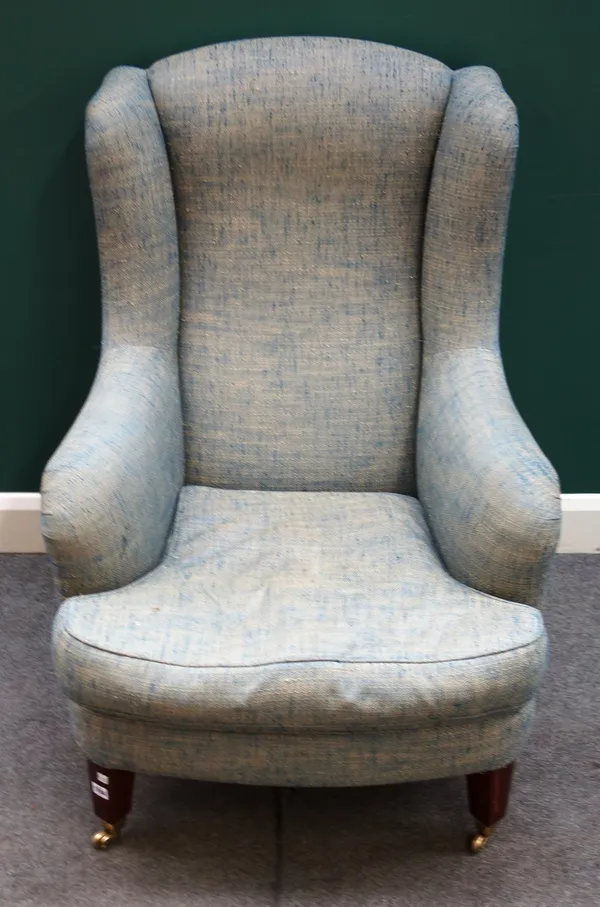 A mid-18th century style wingback armchair, with bow seat on tapering square supports, 75cm wide x 105cm high x 85cm deep, together with a matching fo