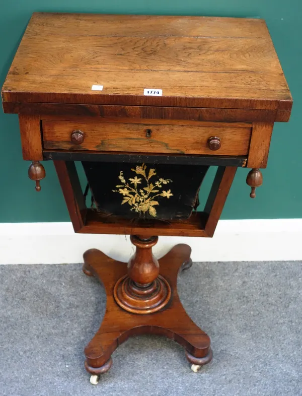 A William IV rosewood sewing/games table, with fold-over fitted drawer and wool basket below, on baluster column and quatrefoil platform, 51cm wide x