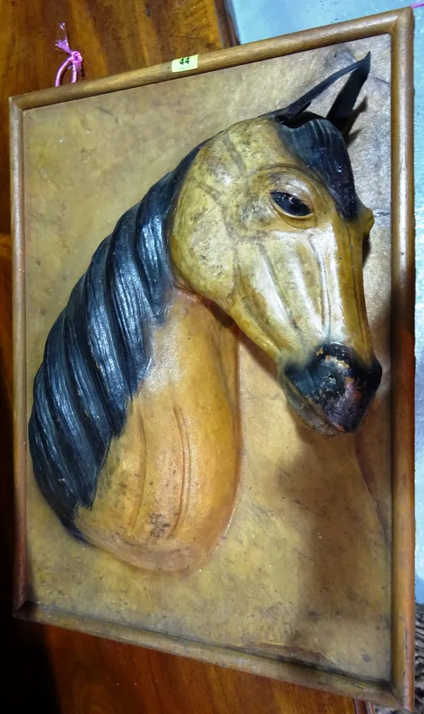 A 20th century brown leather wall plaque modelled as a horse. D11