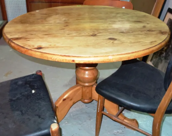 A 20th century pine circular dining table, on an outswept tripod base, 96cm wide x 74cm high.   B4