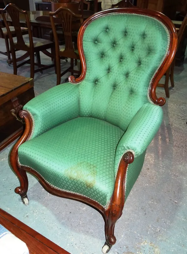A Victorian mahogany framed spoon back armchair, with button back upholstery, on scroll supports.   D8